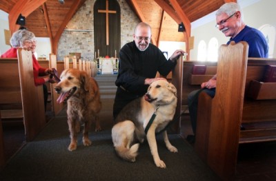 MONTREAL, QUEBEC; MARCH 28, 2013 -- Sandy and Ian Temple and their dogs Toby, left and Myles flank Archdeacon Michael Johnson at Christ Church Beaurepaire in Beaconsfield, west of Montreal Thursday, March 28, 2013. The church offers a monthly service called Paws & Pray to which parishioners can bring their dogs. (John Mahoney/THE GAZETTE)